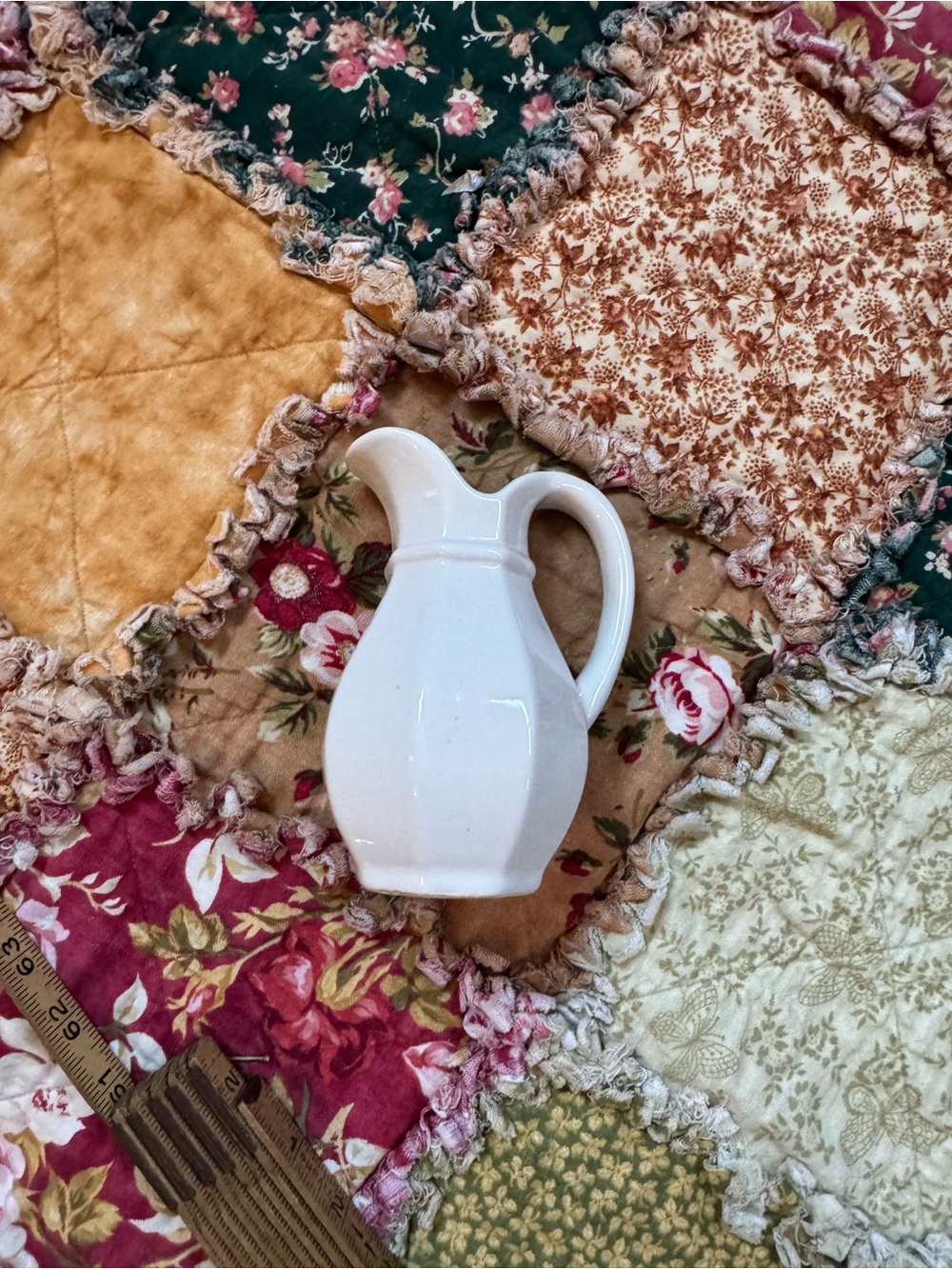 Vintage White Ceramic Pitcher on Floral Patchwork